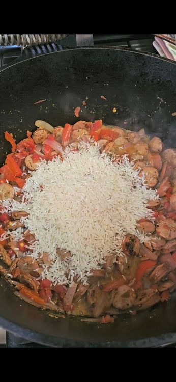 Step 1.3: Stir in the cajun seasoning, diced tomatoes, rice, and chicken bone broth
