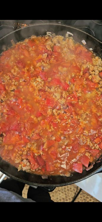 Step 2.2: Add harissa, cumin, and tomatos and mix
