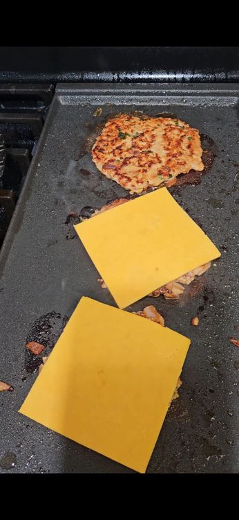 Step 3.1: Add a slice of cheddar cheese on top of the patty so it melts while cooking