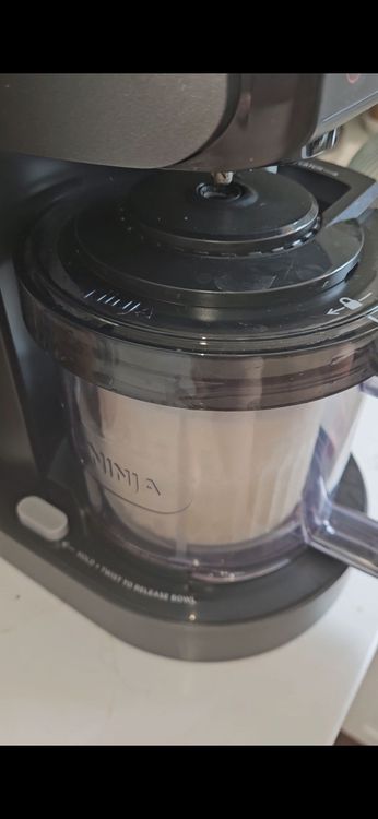 Step 1.2: Once frozen, add a bit of almond milk, place the container into the Ninja Creami and process on the ice cream setting