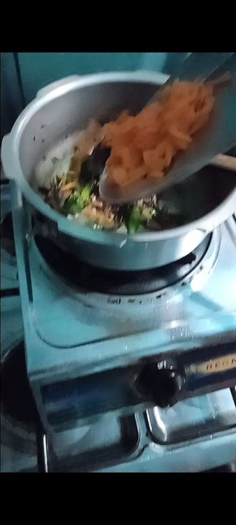 Step 2.2: Toss in the sliced carrots and stir fry for 2-3 minutes until they soften slightly
