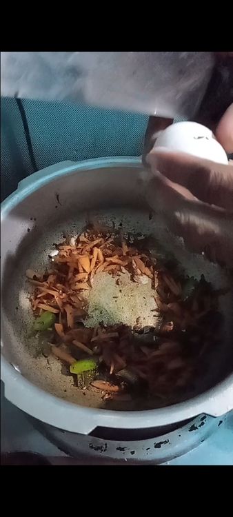 Step 3.1: Push the vegetables to one side of the pan and pour in the beaten eggs on the other side