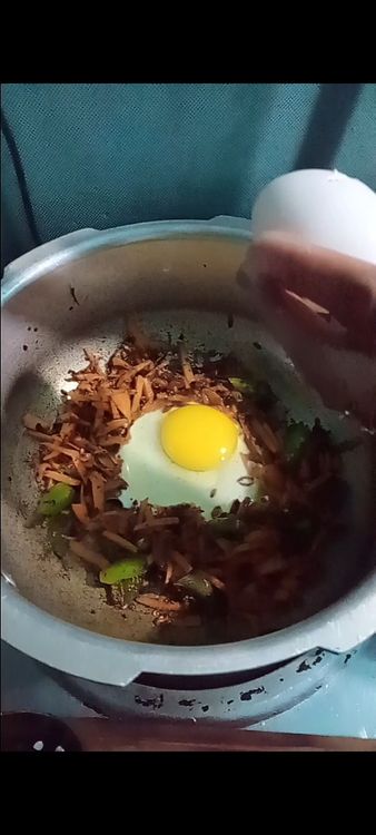 Step 3.2: Push the vegetables to one side of the pan and pour in the beaten eggs on the other side