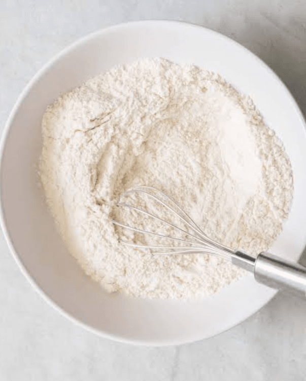 Step 2.1: In a large bowl, combine the all-purpose flour, whole wheat flour, salt, and baking powder