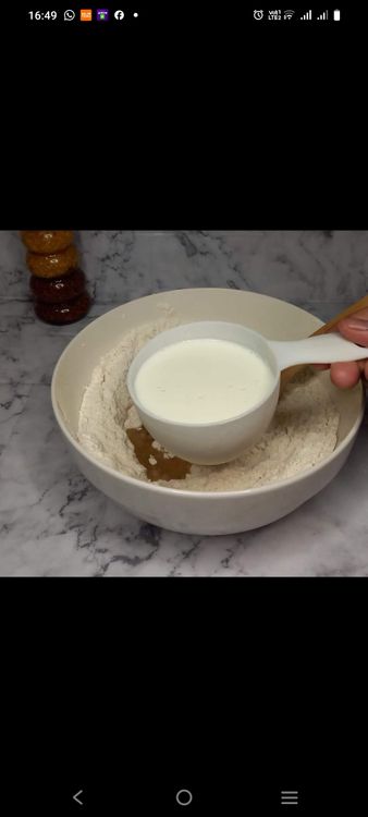 Step 1.2: Add the oil and warm milk to the dry ingredients and mix until a dough forms
