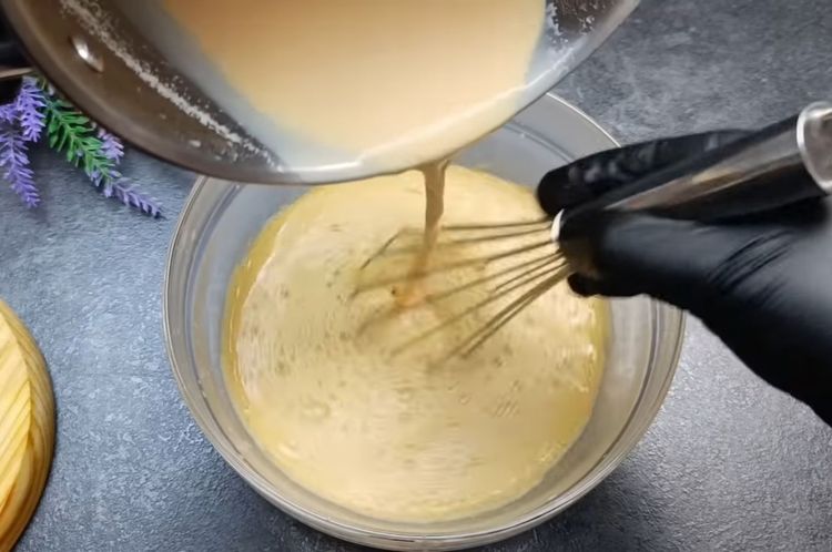Step 4.1: Slowly pour the hot milk into the egg mixture little by little, whisking continuously to prevent curdling