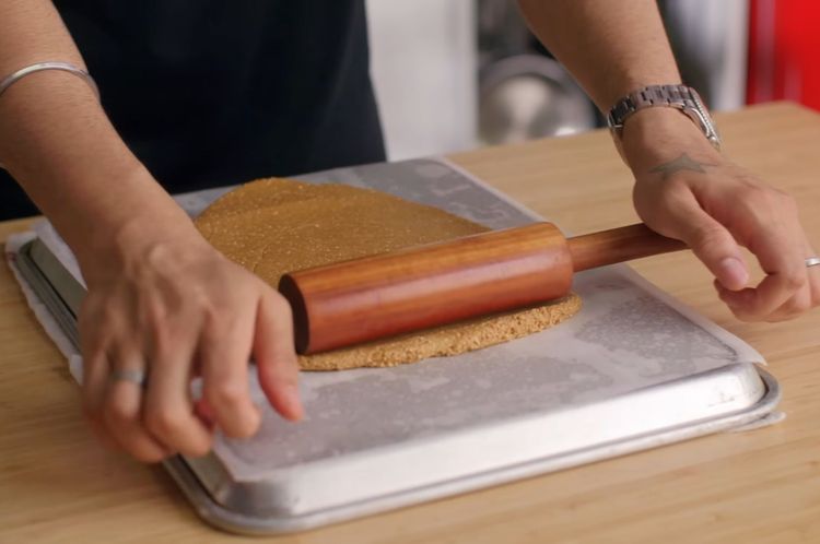 Step 4.1: Transfer onto the butter-paper-lined surface and roll as thin as possible