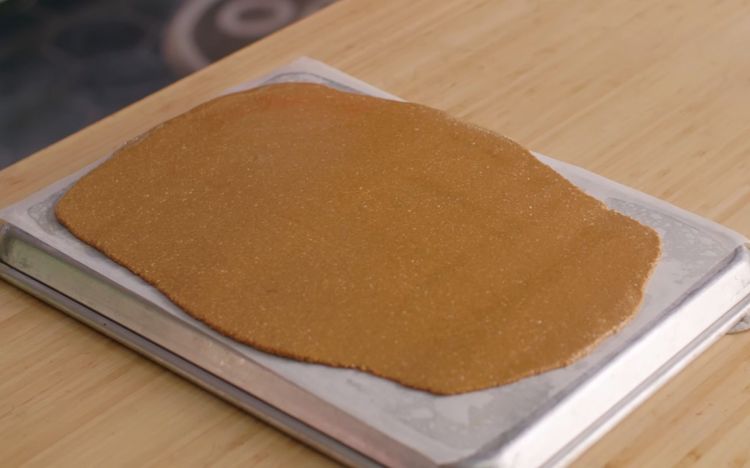 Step 4.2: Transfer onto the butter-paper-lined surface and roll as thin as possible