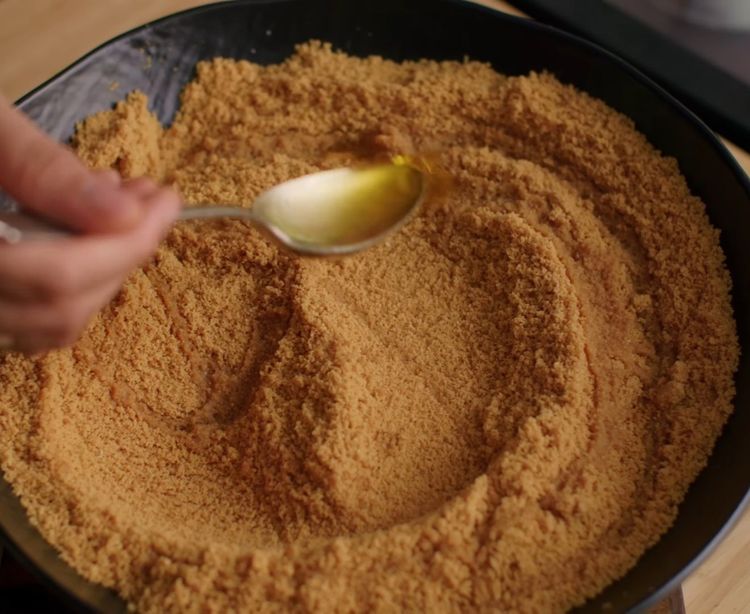 Step 5.1: Add 3 tbsp melted ghee and mix with hands until it holds shape when pressed