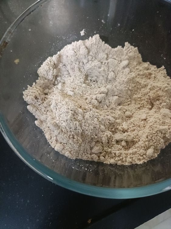 Step 1.1: Add coarsely chopped almonds to the sieved mixture and mix well
