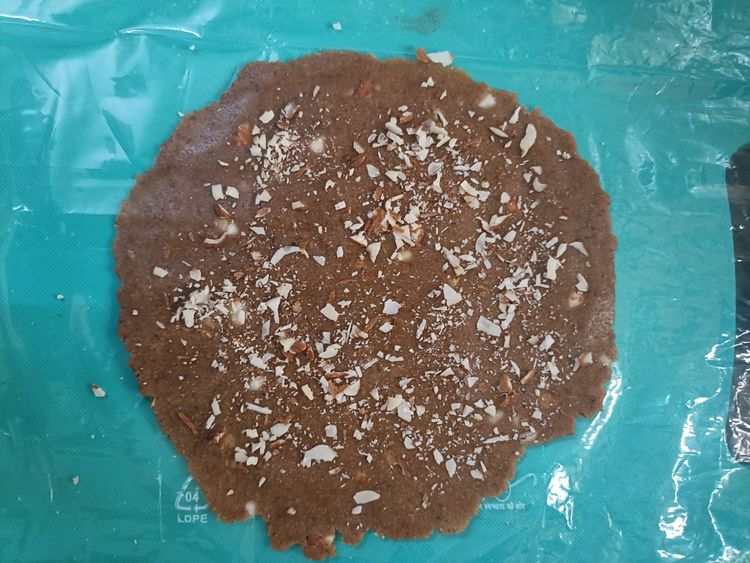 Step 1.1: Take two pieces of parchment paper or plastic and roll out a small portion of the dough