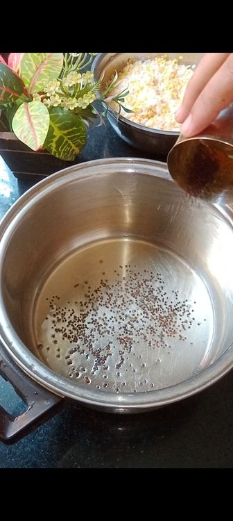 Step 1.2: Heat oil in a pot and to this add mustard seeds and some curry leaves 