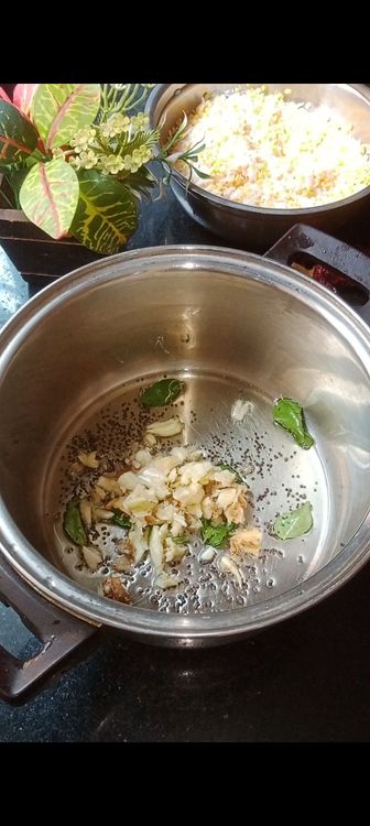 Step 1.3: Heat oil in a pot and to this add mustard seeds and some curry leaves 