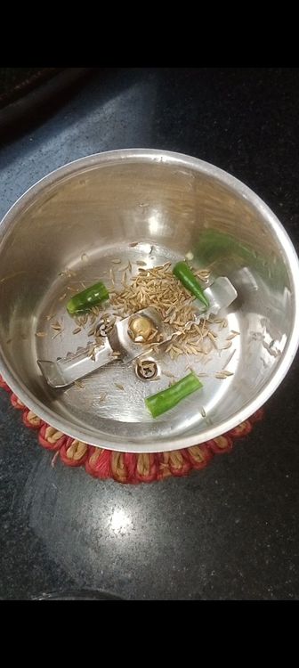 Step 1.2: In a chutney grinder jar , add green chillies, cumin seeds and coriander leaves