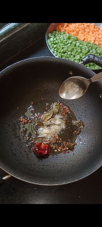 Step 1.1: Once they crackle and turn brownish in colour , add pinch of asafoetida with the chopped veggies