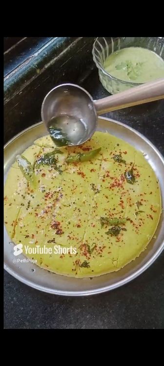 Step 1.1: Pour the sweet tempering over the khaman and serve hot with green chutney