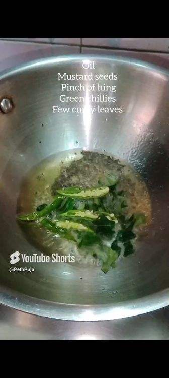 Step 1.1: For tadka , in a wok or pan , add oil , mustard seeds, green chillies, pinch of asafoetida , few curry leaves