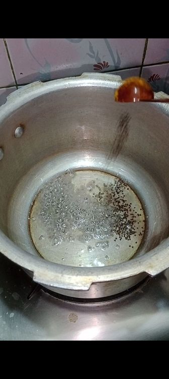 Step 1.2: Heat oil in a pressure cooker and add mustard seeds followed by cumin seeds and asafoetida