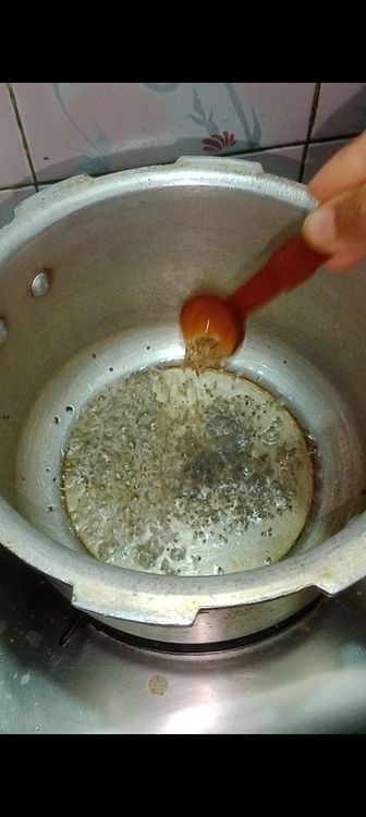 Step 1.3: Heat oil in a pressure cooker and add mustard seeds followed by cumin seeds and asafoetida