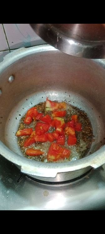 Step 1.1: Once mustard seeds and cumin seeds crackle , add tomato cubes and mix well