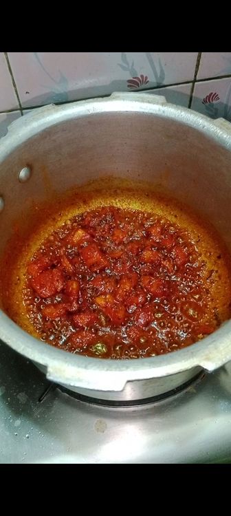 Step 1.1: Once tomato gets properly mashed with masalas , add beaten homemade curd, mix well and simmer for 2 min till oil separates