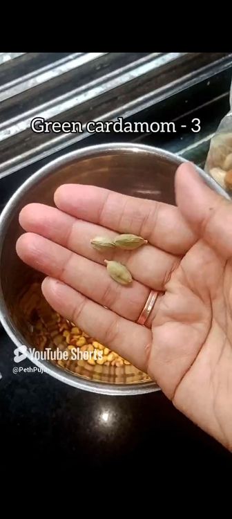 Step 1.2: In a mixie jar, put roasted chana dal, green cardamom pods, grated coconut, rice flour, jaggery powder, water and pinch of salt