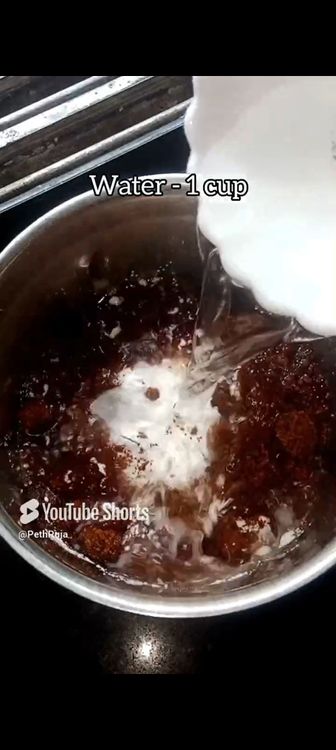 Step 1.7: In a mixie jar, put roasted chana dal, green cardamom pods, grated coconut, rice flour, jaggery powder, water and pinch of salt