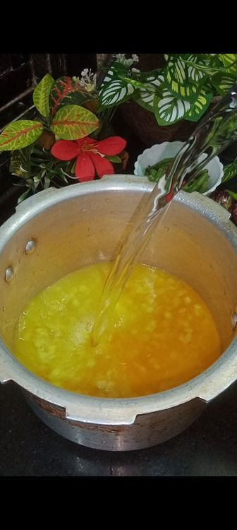 Step 1.3: In a cooker , add boiled toor dal , turmeric powder and water