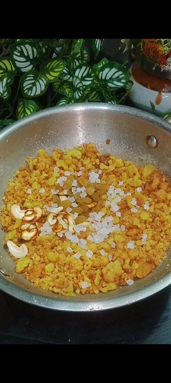 Step 3.1: Once the mixture cools down and boondis absorb the syrup , add fried cashews, raisins, rock sugar , cardamom and pinch of edible camphor