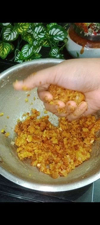 Step 3.2: When the mixture is warm (not too hot or cold), grease your hands with ghee and shape the boondi into small, round laddus
