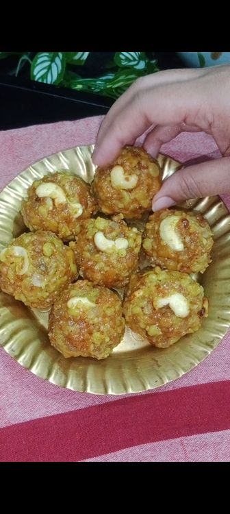 Step 3.3: When the mixture is warm (not too hot or cold), grease your hands with ghee and shape the boondi into small, round laddus