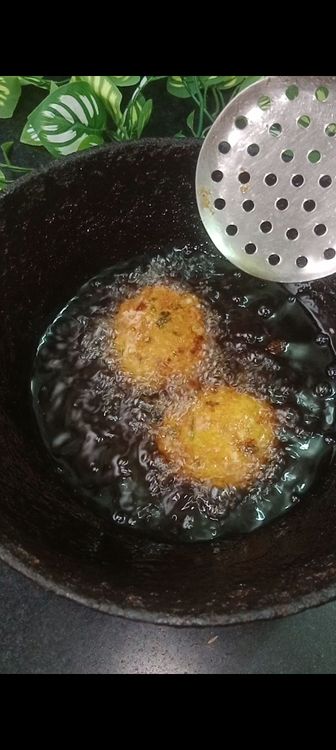 Step 2.2: Carefully drop the vadas into the hot oil