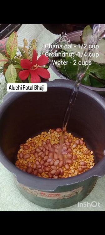 Step 1.1: In a pressure cooker , add chana dal , peanuts , water , chopped arbi leaves and it's stem