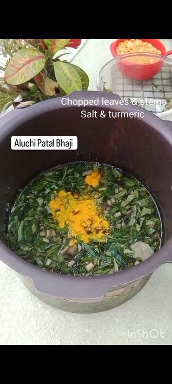 Step 1.4: In a pressure cooker , add chana dal , peanuts , water , chopped arbi leaves and it's stem