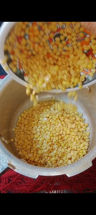 Step 2.1: In a pressure cooker, add soaked dal , red chilli powder and turmeric powder 