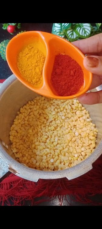 Step 2.2: In a pressure cooker, add soaked dal , red chilli powder and turmeric powder 