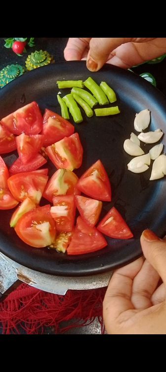 Step 2.1: Add chopped tomatoes , green chillies and crushed garlic pods ( this gives a nice aroma to dal ) followed by salt and sufficient water to cook dal ( for  1 cup toor dal I used 2 cups water )