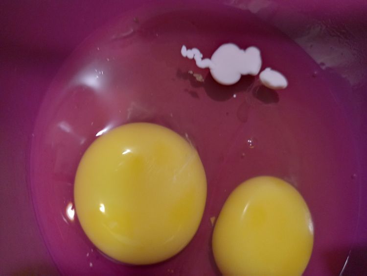 Step 1.1: In a smaller bowl, break in the eggs and add the milk essence