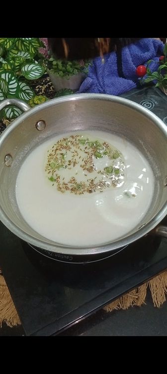 Step 2.2: In a tadka pan , heat 1/2tbsp peanut oil or ghee, next add cumin seeds, green chillies and chopped ginger