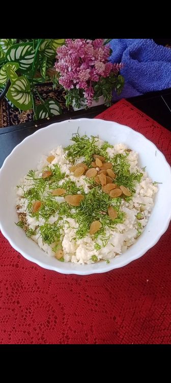 Step 1.2: Transfer to a bowl , add mashed boiled potatoes, paneer, coriander leaves and raisins