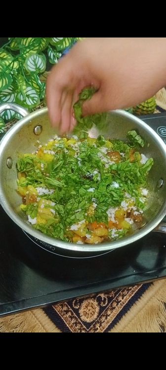 Step 1.2: Add Grated coconut and chopped spinach