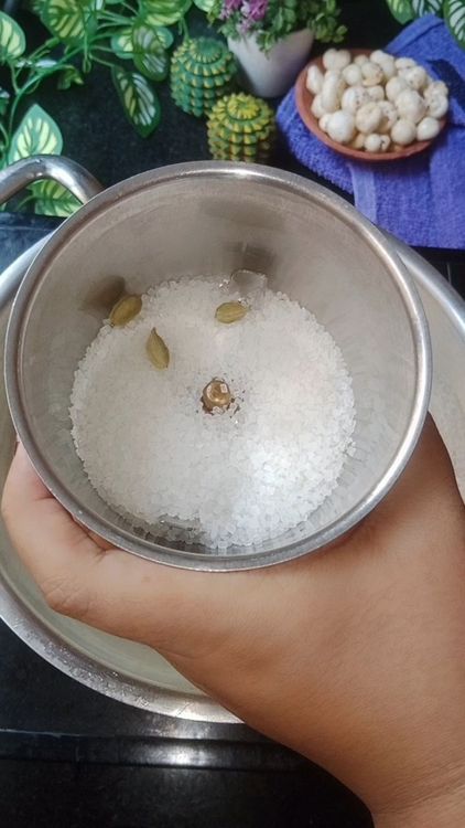 Step 1.1: In a mixie jar, add sugar and green cardamom and grind into fine powder
