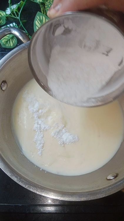 Step 1.2: In a mixie jar, add sugar and green cardamom and grind into fine powder