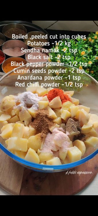Step 1.1: In a mixing bowl, combine the boiled potatoes with sendha namak, black salt, black pepper powder, roasted cumin seeds powder, anardana powder, red chilli powder, jaggery powder, and sugar