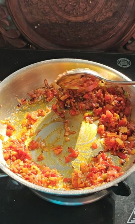 Step 1.1: Add chopped tomato, turmeric powder, and Kashmiri red chili powder