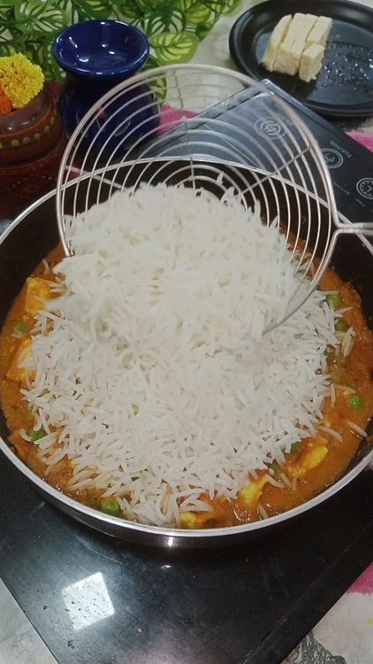Step 1.1: Add boiled rice and assemble paneer , coriander leaves , pinch of biryani masala and pinch of black pepper powder