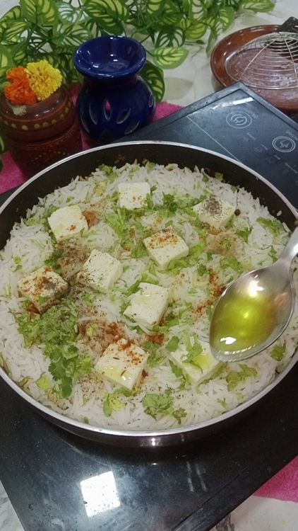 Step 1.2: Add boiled rice and assemble paneer , coriander leaves , pinch of biryani masala and pinch of black pepper powder