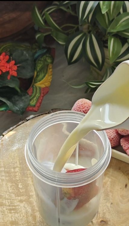 Step 1.1: In a blender, combine the milk, pitted dates, and 6 frozen strawberries to make a strawberry shake