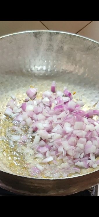 Step 2.1: In the same ghee, add cumin seeds and chopped onion