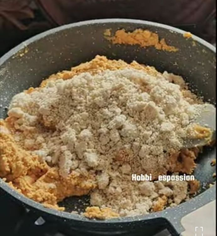 Step 3.1: Remove from flame, add the dry fruits mixture, dessicated coconut, and Desi Khand